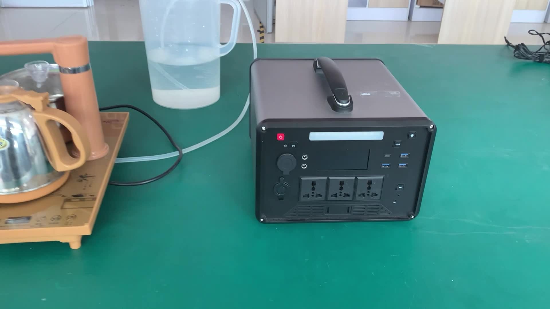 Portable power station connected to a boiling water kettle.mp4